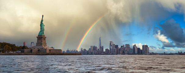 Panoramic view of the Statue of Liberty and Downtown Manhattan in the background. Dramatic Sky with Rainbow Artistic Render. Taken in New York City, NY, United States.