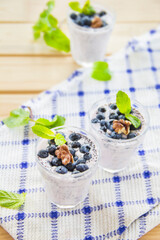  Juicy and fresh blueberries with green leaves. Creative atmospheric decoration