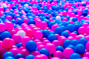 Colorful plastic balls on childrens playground white pink and blue