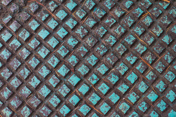 Rusty old Round manhole cover, painted in turquoise color