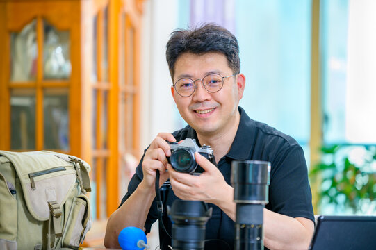 A middle-aged Asian man whose hobby is 35mm/135mm film SLR camera. - Powered by Adobe