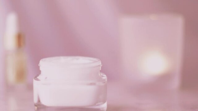 Pink skincare product line, face cream jar for healthy body care routine, organic cosmetic and beauty brand, stock footage