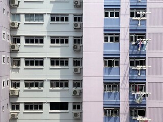 Singapore, 6 October 2020: Rows of windows on govt apartments. Laundry hanging system. Air...