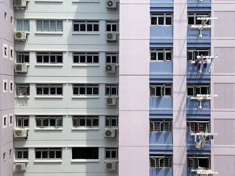 Singapore, 6 October 2020: Rows Of Windows On Govt Apartments. Laundry Hanging System. Air Conditioner Compressors Hanging Out On The Facade. 