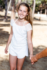 Naklejka premium Portrait of teen girl keep grandmother on hand in summer green park