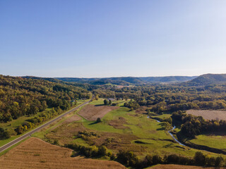 Fototapeta premium landscape with mountains and sky looking down a long highway at the base of the bluffs in La Crosse, Wisconsin