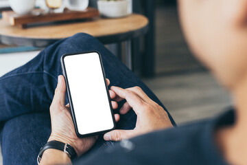cell phone mockup blank white screen.man hand holding texting using mobile on desk at coffee shop.background empty space for advertise.work people contact marketing business,technology