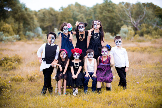 Asian children boys and girls sugar skull face paint on Halloween.