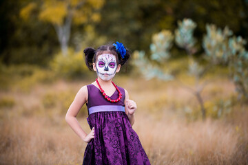 Asian girl sugar skull facepaint with flower on Halloween.