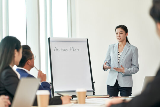 young asian businesswoman speaking during team meeting
