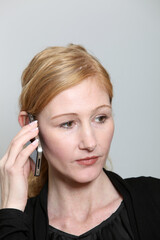 Sad, young woman on the phone