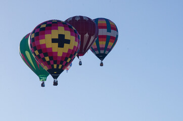 A cluster of hot air balloons in flight.