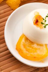 Vanilla Panna Cotta Dessert with lemon and fresh herbs
