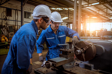 Industry engineer wearing safety uniform used Vernier caliper to measure the object control operating machine working in industry factory