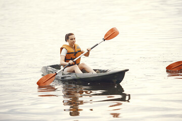 Kayaking. A woman in a kayak. Girl paddling in the water.