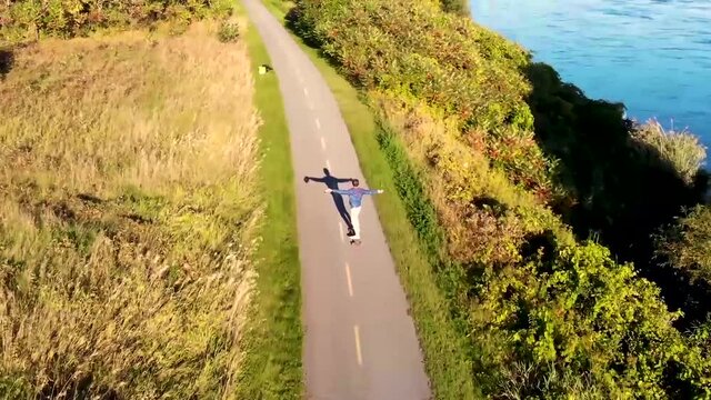 skateboarding, longboarding down a countryside road