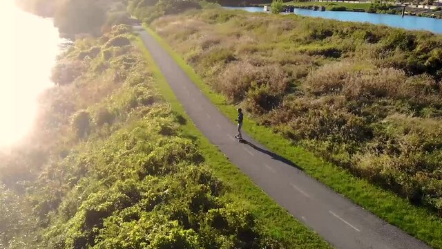 skateboarding, longboarding down a countryside road