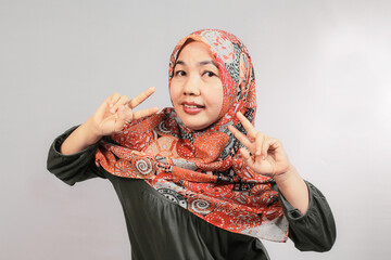 Asian female portrait brandishing a peace sign two fingers