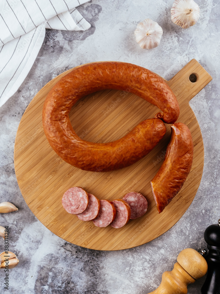 Wall mural fresh homemade sausage on a light background with vegetables