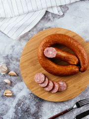 fresh homemade sausage on a light background with vegetables