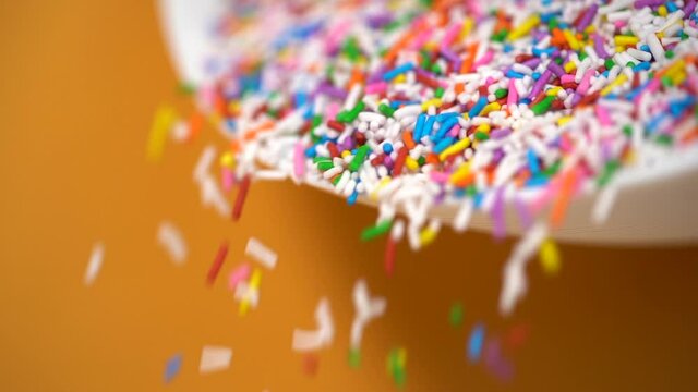 Pouring a bowl of cupcake sprinkles in slow motion