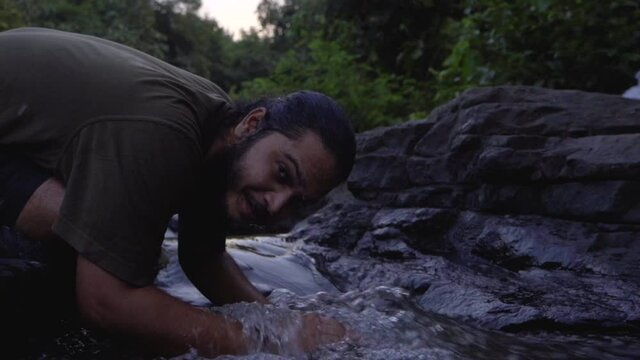 vivek bearded long hair man rlaxingplaing with water