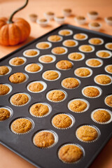 Mini Muffins with a Fall Theme and Halloween Decorations in Muffin Pan