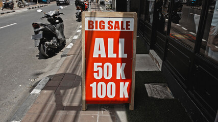 Text on a red sign labeled big sale