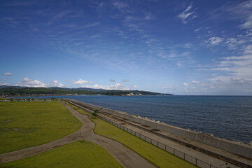 Green park near sea front with ocean on the background. Toyama, Japan.