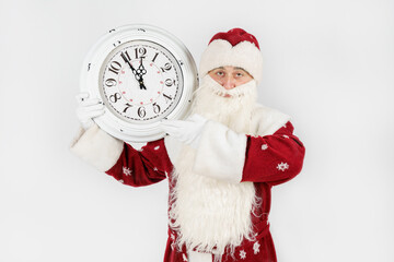 Santa Claus shows the time remaining before Christmas on the clock. Isolated on white