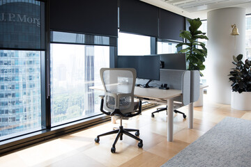 Office with a view of the cityscape from the near by window with plenty of natural light modern...