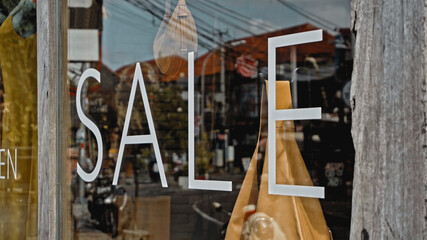 White text on a glass window with the inscription sale