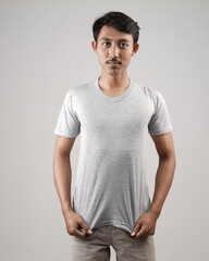 Obraz premium Young men in empty gray T-shirts, stylish and posing like famous T-shirt models. Men's t-shirt template and mockup design for print. photo shoot models isolated white background.
