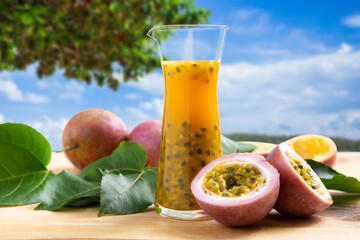 Passion fruits half and juice on the beach.