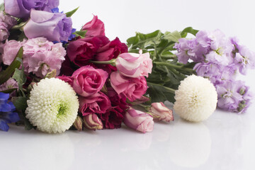 bouquet of pink and violet lisianthus flowers on white background.