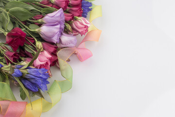 bouquet of pink and violet lisianthus flowers on white background.