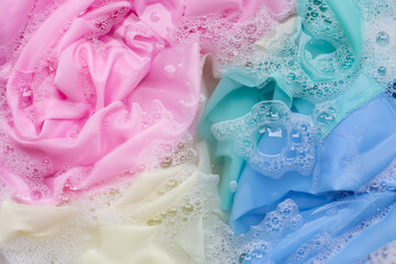 Color clothes soak in powder detergent water dissolution. Laundry concept