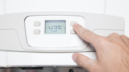 Hand adjusting room temperature. Apartment