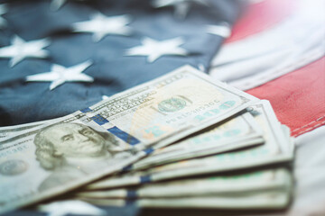 American dollars banknotes on the flag of United States. US dollars background. 100 USD