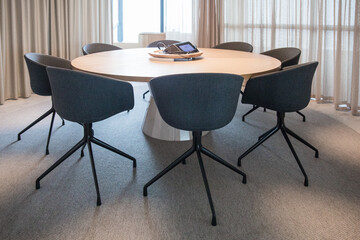 A conference business room for training and business activities with desks and chairs set up for learning and education. Work place office environment. 