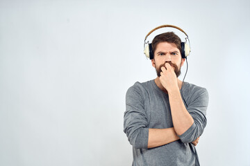 Man in headphones listens to music lifestyle modern style technology light background