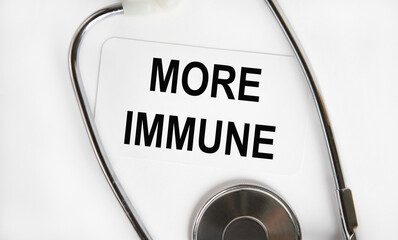 On the business card is the inscription MORE IMMUNE, next to the stethoscope.