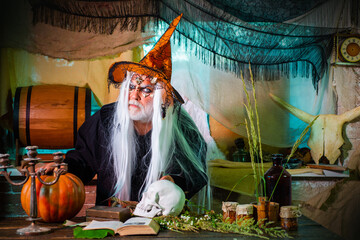 Halloween Scene with bloody man devil. Devil man with skull with bloody face. Devil in wicked witch...