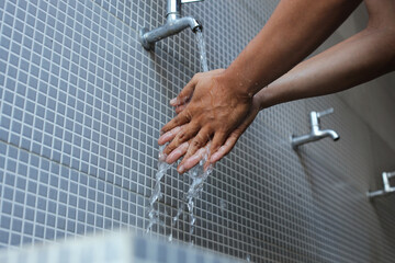 A moslem man take ablution, known as wudu, as one of ritual purification to pray : washing hand for...