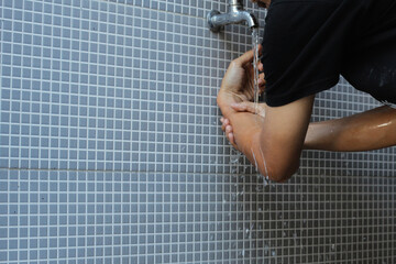 A moslem man take ablution, known as wudu, as one of ritual purification to pray : washing arm