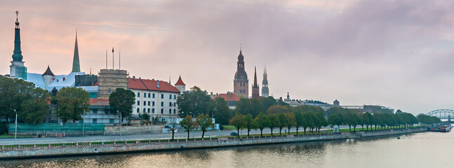 Obraz premium Medieval churches in old district of Riga - the capital and largest city of Latvia, a major commercial, cultural, historical and tourist center of the Baltic region.