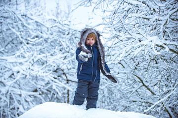 Fototapeta na wymiar Winter kids leisure. Children run on snowy field. Happy children on nature walks in the winter. Enjoying nature wintertime.
