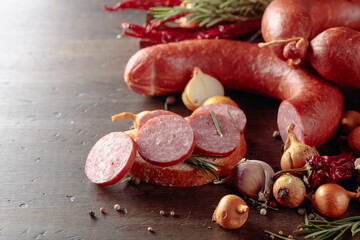 Sandwich with salami on a old wooden table.