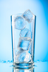 pieces of pure real ice in a glass on a colored gradient background, cubes are rounded