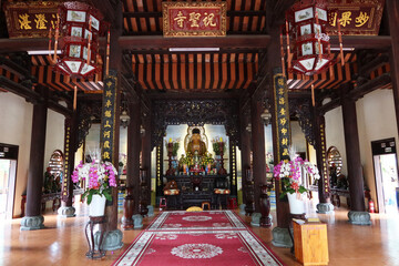 Hoi An, Vietnam, February 21, 2020: Main hall with a Buddha image in Chùa Chúc Thánh temple. Hoi An, Vietnam